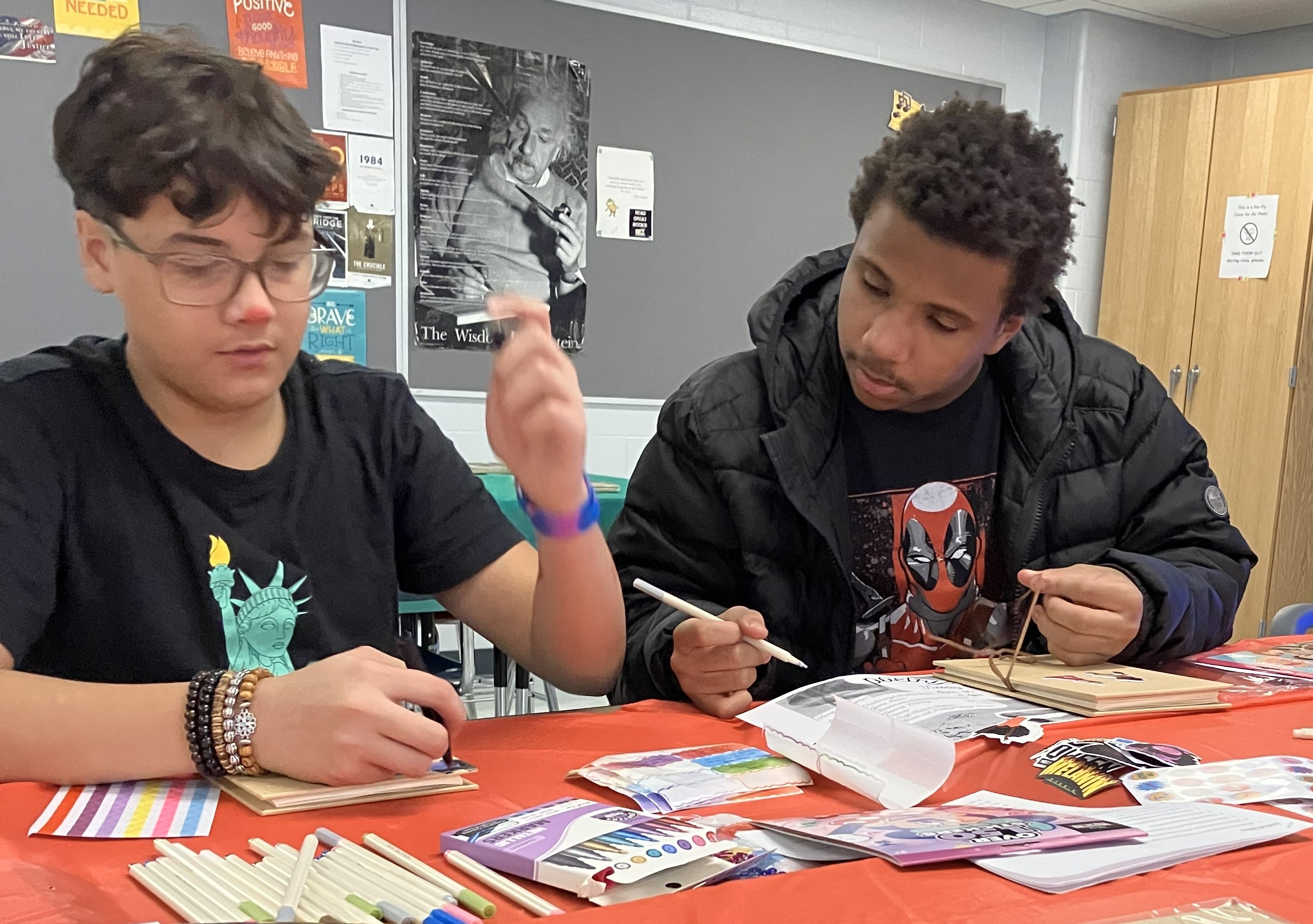 Teens working on arts and crafts projects at after school program