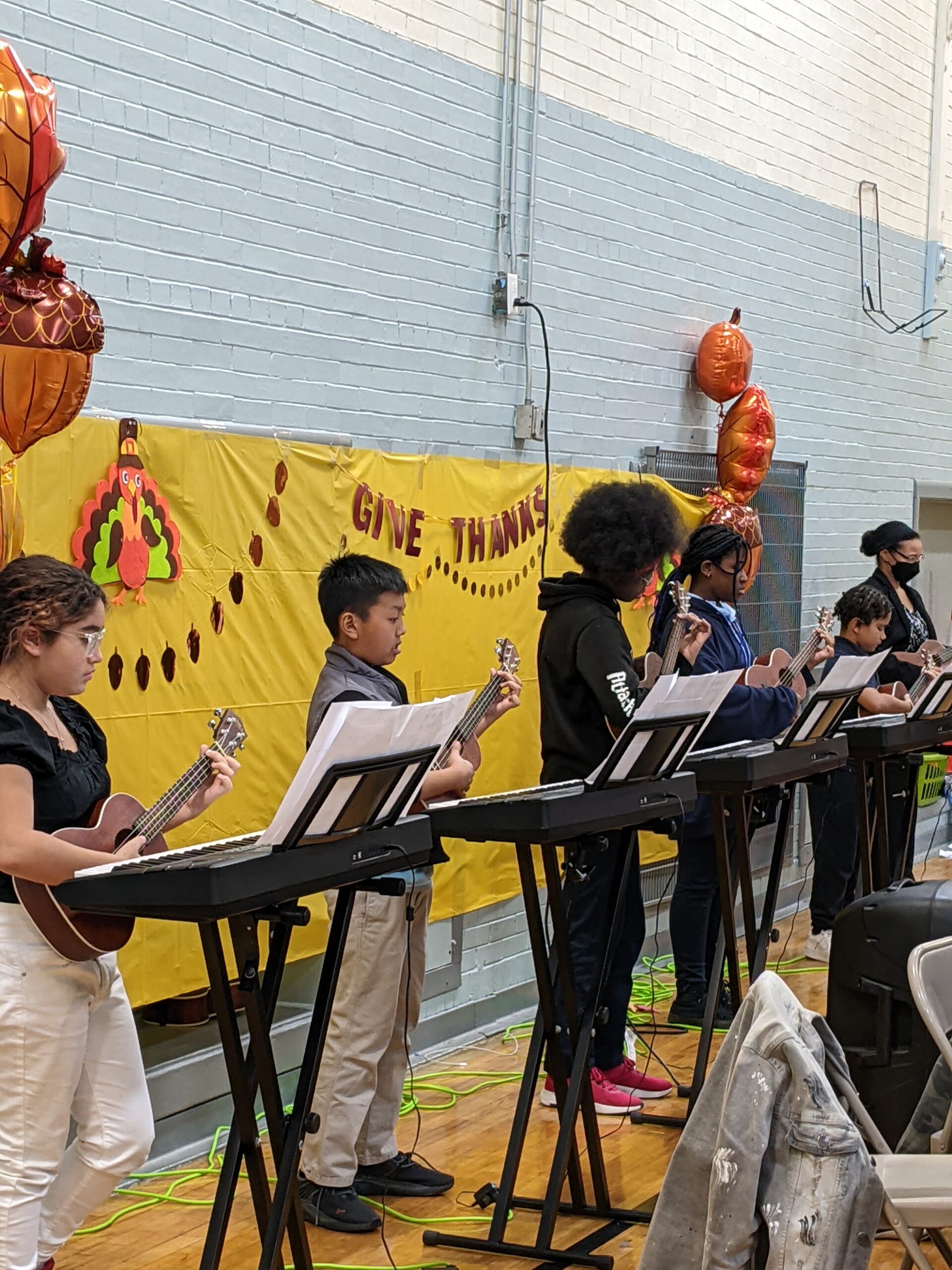 Youth playing ukuleles at NWBCC Thanksgiving music performance